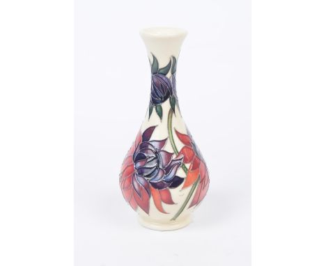 A Moorcroft "Ruby Red" contemporary vaseOf bottle form, the ivory ground picked out with purple and red tube lined flowers, f