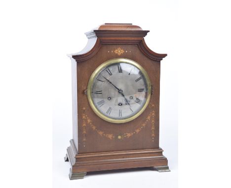 An Edward Gustav Becker eight day Westminster chime mahogany bracket clockOf architectural form inlaid with ribbon tied swags