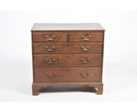A Georgian oak chest of drawersThe rectangular moulded top above two short and three long graduated drawers each applied with