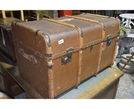 A Vintage travel trunkThe canvas trunk with four Bentwood slats applied with clasp locks and metal embellishments, 81x52x51cm