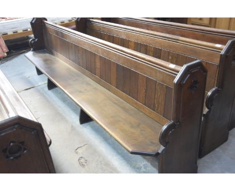 A Victorian oak church pewThe rectangular seats with canted front corners raised on shaped bracket type supports and fitted w