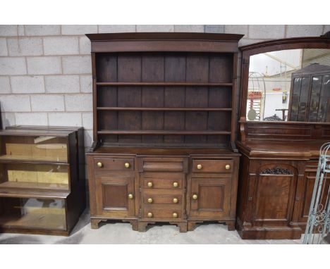 A mid 19th Century Anglesey oak dresserThe high back with a moulded cornice above a plain frieze and three enclosed shelves a