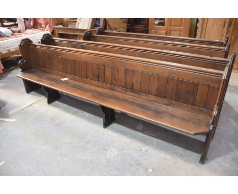 A Victorian oak church pewThe rectangular seats with canted front corners raised on shaped bracket type supports and fitted w