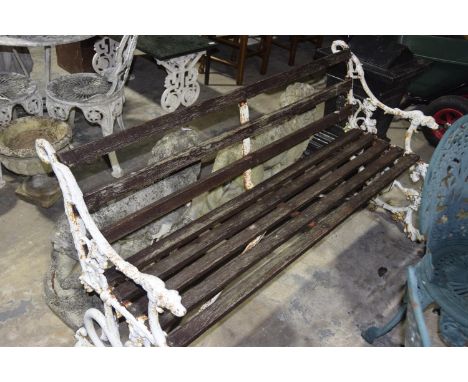 A 19th Century Coalbrookdale style garden benchThe slatted hard wood bench with cast end brackets each with down swept arms t
