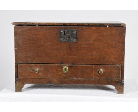 An unusual 17th Century oak coffer of small proportionsThe rectangular moulded hinged top above a lower frieze drawer, raised