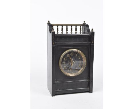 A late 19th/early 20th Century black slate eight-day mantel clock The architectural casing inscribed with stylized foliate de