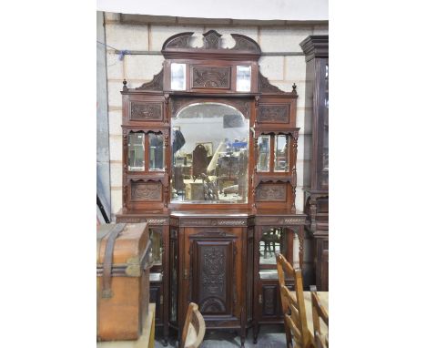 A late Victorian walnut mirror back chiffonier sideboardThe architectural high back with carved panels and a central arched m