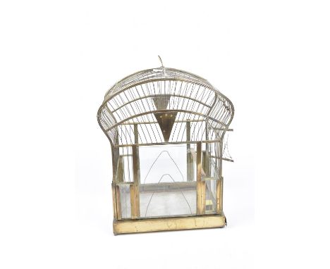 A 1920's vintage brass birdcage Of typical form the upper rounded top extending to glazed sides with internal wooden perch an