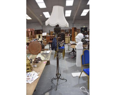 An early 20th Century gilt metal paraffin standard lamp Converted to electricity, the scrolling supports extending to a centr