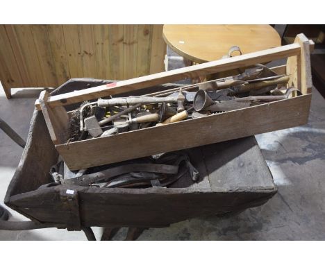 A vintage hardwood wheelbarrowMounted on an iron tubular frame with a collection of tools to a pine box and assorted leather 