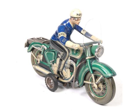 A Tipp & Co tinplate friction driven motorbikeIn green with police rider in blue top, black trousers and boots and white helm