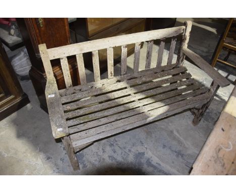 A slatted hardwood garden bench Raised upon legs of square section, 128cm wide. 