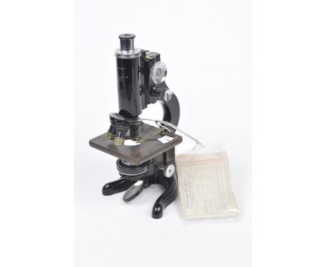 An early 20th Century Watson & Sons microscopeThe black painted cast metal microscope with adjustable stage and three lens an