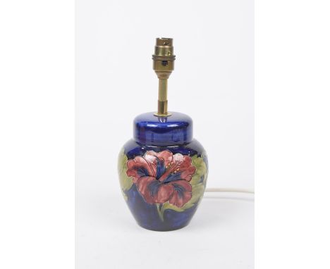 A Moorcroft "Hibiscus" pattern lamp baseOf ovoid form, the blue ground picked out with pink and purple flower heads in green 