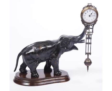 A German elephant mystery clock, c.1900The standing patinated spelter figure of an elephant with raised trunk suspending a gi