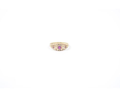 An Edwardian 18ct gold ruby and diamond dress ringThe circular shape ruby and single cut diamond line with scrolling sides, B