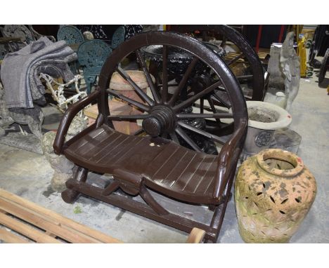 A painted hardwood garden bench constructed from a 19th Century cartwheelThe wheel back with a painted iron rim above the rus