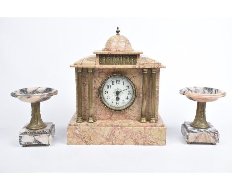 A late 19th Century French rouge marble clock The central clock of architectural form with domed top and cast gilt metal plas