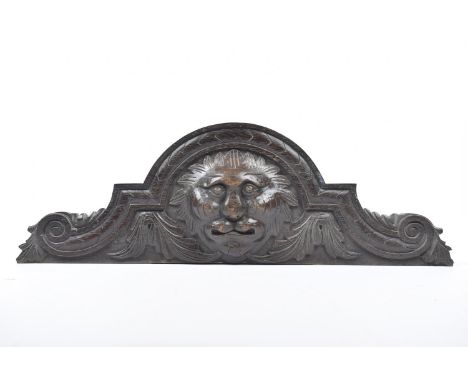 A large carved oak architectural door pedimentThe carved scroll sides extending to a arched top, carved in high relief with d