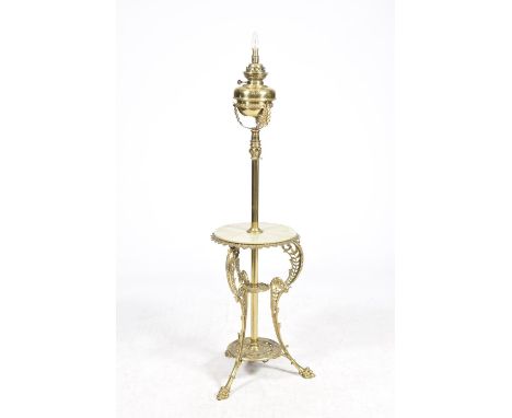 An early 20th Century brass lamp standardThe brass circular reservoir mounted on three leafy supports upon a cylindrical tele