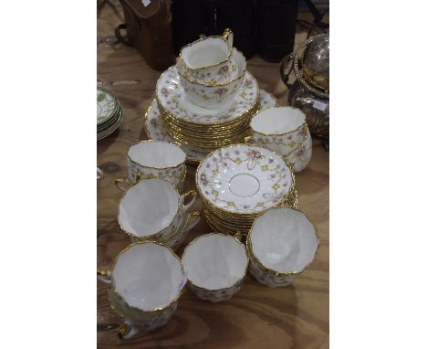 A Salisbury "Bow" pattern porcelain tea serviceComprising eleven various teacups, twelve saucers, sugar bowl, twelve tea plat