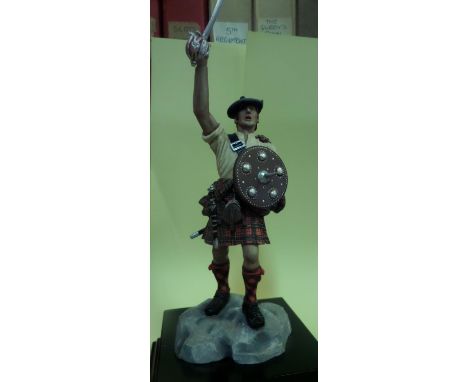 A Stadden figure of a Highland Chieftain,  c 1745, complete with targe and drawn sword, mounted on a square wooden plinth, 5"