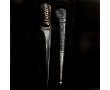An Afghan dagger pesh kabz. Late 19th century, T-section blade 16cms, iron grip strap, 2 piece spiral carved horn grips, in i