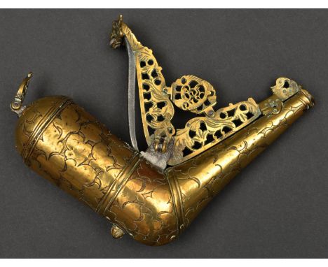 A Persian brass powder flask of horn shape. Late 19th century, 16cms, engraved with foliage overall, pierced brass charger le