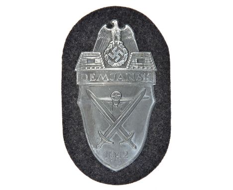 A Third Reich Demjansk arm shield, on Luftwaffe grey/blue cloth patch with paper backing. GC, apparently unissued. 