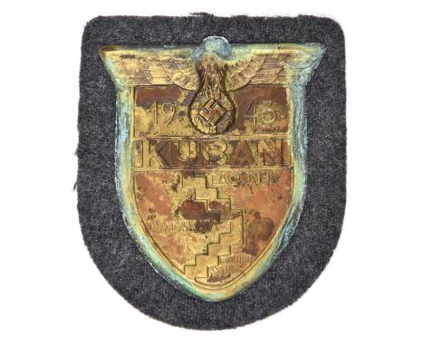 A Third Reich Kuban arm shield,  on Luftwaffe grey/blue cloth patch with paper backing. GC, apparently unissued (verdrigris a