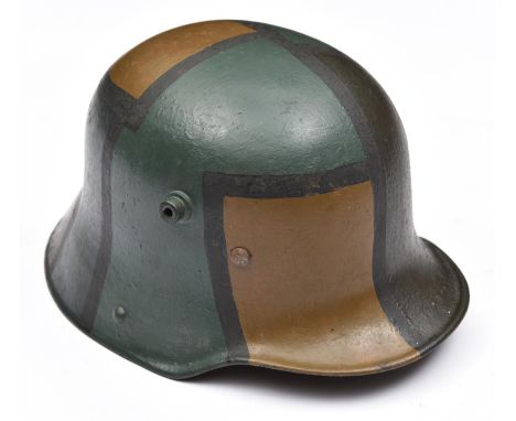 The skull of a 1916 pattern German steel helmet,  the inner rim stamped with "K64" size code, repainted with dazzle camouflag