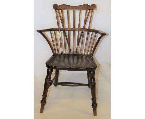 A 19th century comb back windsor chair in elm/yew. GC. £30-50 