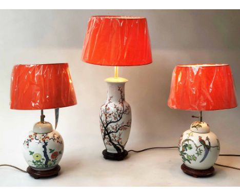 LAMPS, a pair, Chinese ceramic ginger jar form, birds and blossom together with a larger matching vase form lamp, 52cm H and 