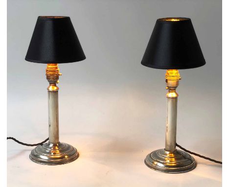 CANDLESTICK LAMPS, a pair, silvered metal, each with column and base, 34cm H. (2)