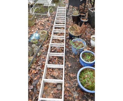 AN ALUMINIUM DOUBLE EXTENSION LADDER with thirteen rings to each 353cm length