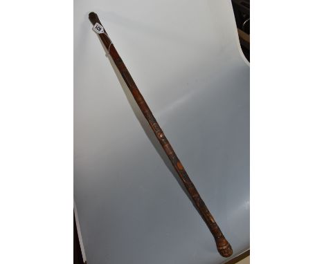 A JAPANESE MEIJI PERIOD SAMURAI CARVED BAMBOO WALKING STICK carved in relief with five carved faces to include a 'tengu/demon