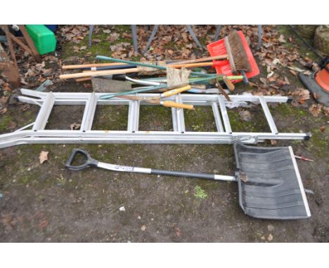 A COLLECTION OF GARDEN TOOLS AND A STEP LADDER, including snow shovels, clippers, spades, etc.