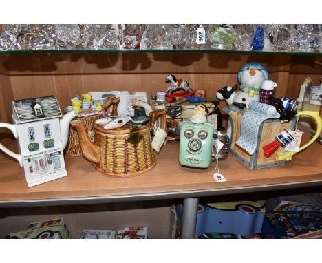 A COLLECTION OF SEVEN NOVELTY TEAPOTS, comprising a Swineside Ceramics 'Teapottery' The Acme Steam Bath, a  Cardew 'Christmas