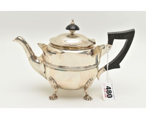 AN EARLY 20TH CENTURY SILVER TEAPOT, polished teapot with wavy rim, fitted with an ebonised handle and finial, raised on four