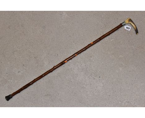 A LATE VICTORIAN HORN HANDLED SWORD STICK, the cane fitted with a 29cm square tapered steel blade with decoratively shaped ed