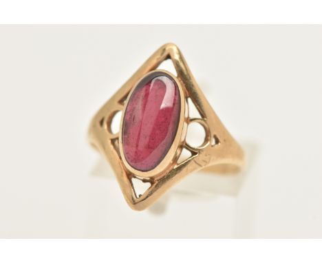 A 9CT GOLD GARNET RING, collet set with an oval cut garnet, within an open work diamond shape mount and polished band, hallma