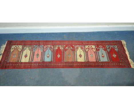 A 20TH CENTURY TURKISH MIDJUR CARPET RUNNER, with ten repeating patterns, surrounded by a multi-strap border, 260cm x 64cm, c