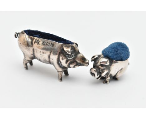 TWO SILVER NOVELTY PIN CUSHIONS, the first in the form of a pig with a blue fabric cushion, makers mark 'Boots Pure Drug Comp