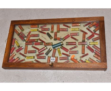 A GLAZED DISPLAY CASE CONTAINING APPROXIMATELY EIGHTY  8, 10, 12 BORE AND .410 GUN CARTRIDGES, brands include Holland &amp; H