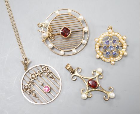 Three early 20th century yellow metal and gem set pendants or brooches, including sapphire and seed pearl, garnet and seed pe