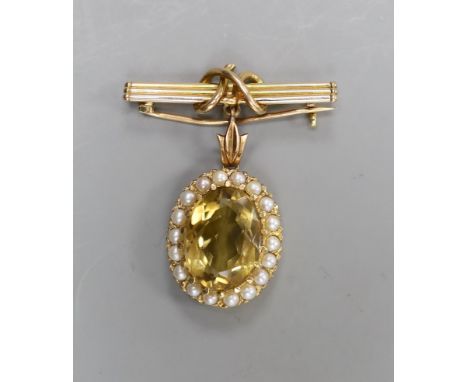 An early 20th century yellow metal, citrine and split pearl set oval pendant, overall 33mm, on a yellow metal suspension bar 