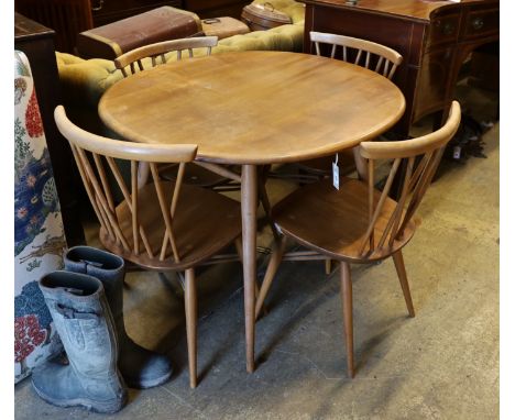 An Ercol elm and beech oval dining table, width 99cm, depth 89cm, height 71cm and four Chiltern chairs