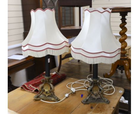 A pair of bronze table lamps, the bases cast with griffins and anthemion