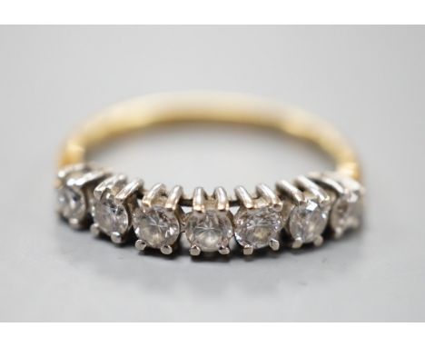 An 18ct gold and seven stone diamond set half hoop ring, size K, gross weight 1.8 grams.