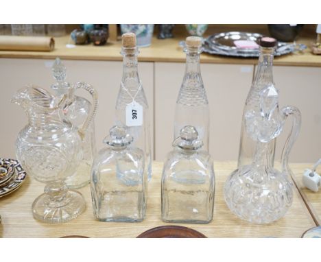 A Victorian cut glass Claret jug and stopper, a step cut pedestal jug, a pair of Dutch decanters, a large Dutch decanter and 